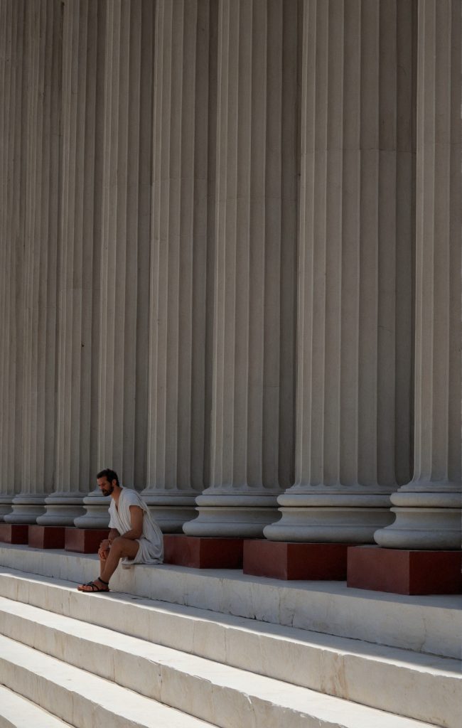 Man Taking Refuge from the Sun at the Temple